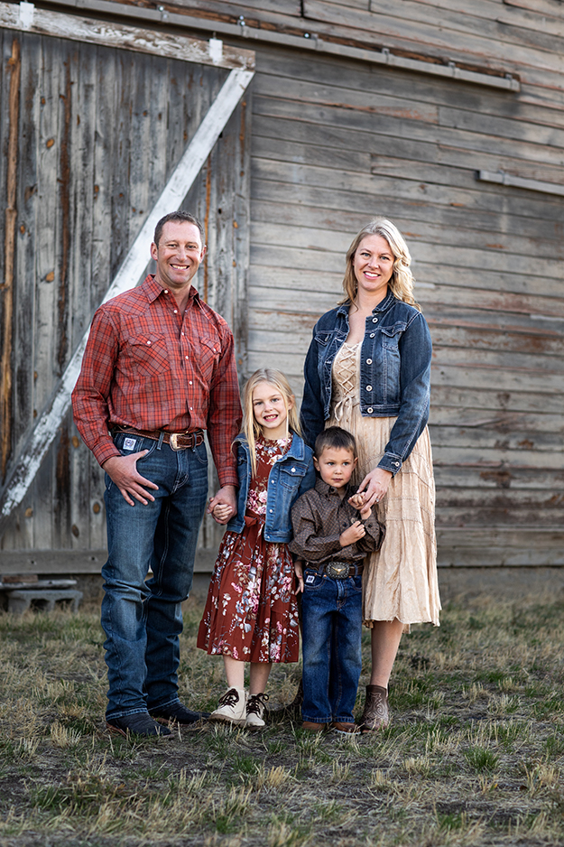 The Haberman Family standing in front of a barn.
